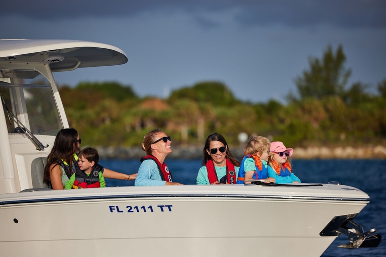 Women and kids in life jackets on a boat, boating safety tips for families concept. 