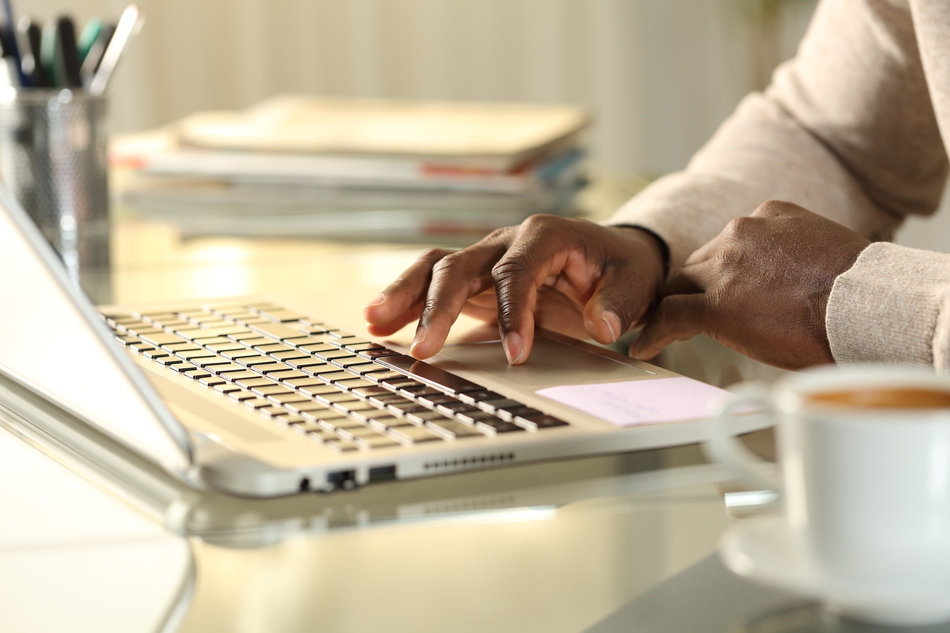 Close-up of a hand on laptop keyboard, taking boating courses online concept. 
