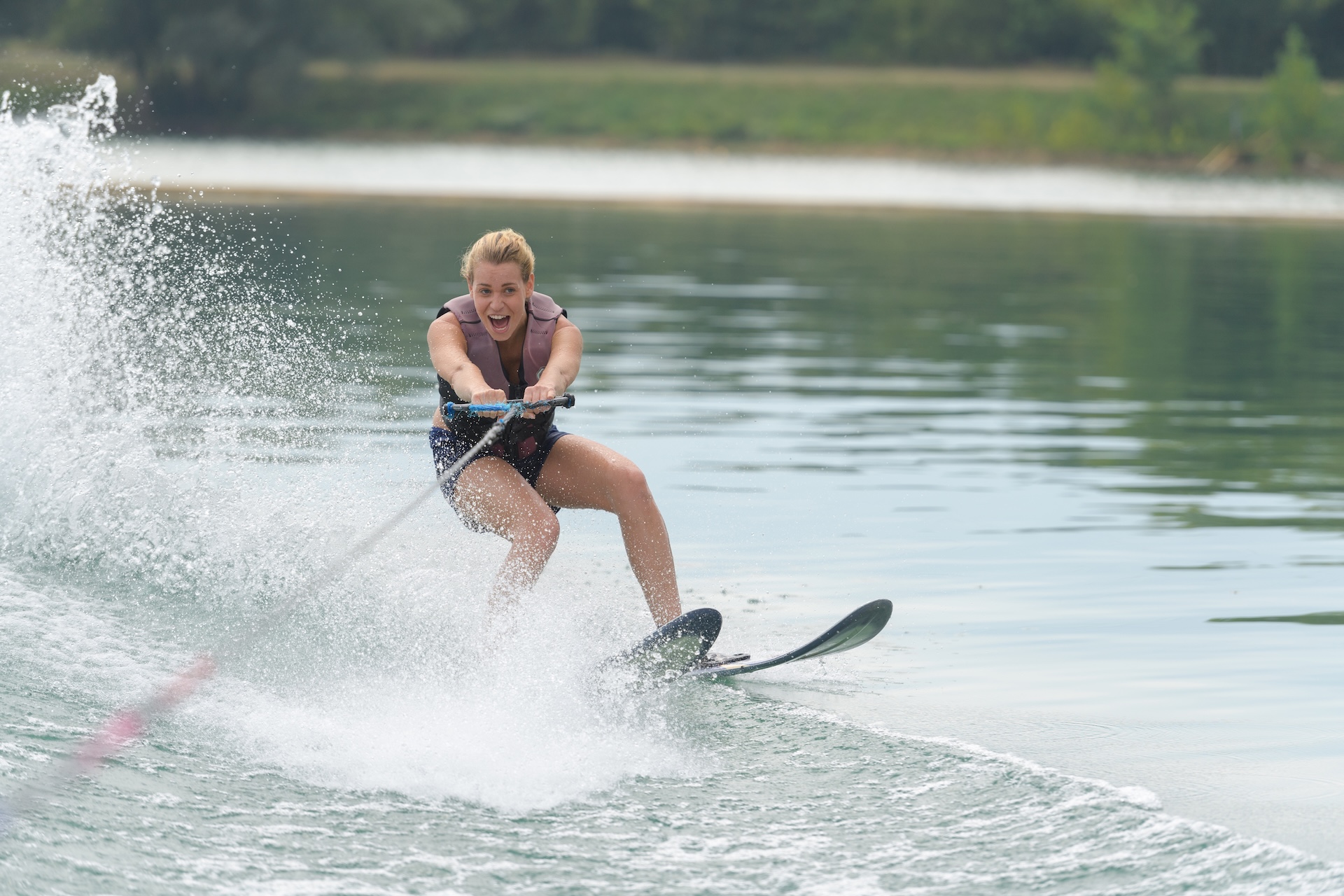 A girl water skiing on a lake. 