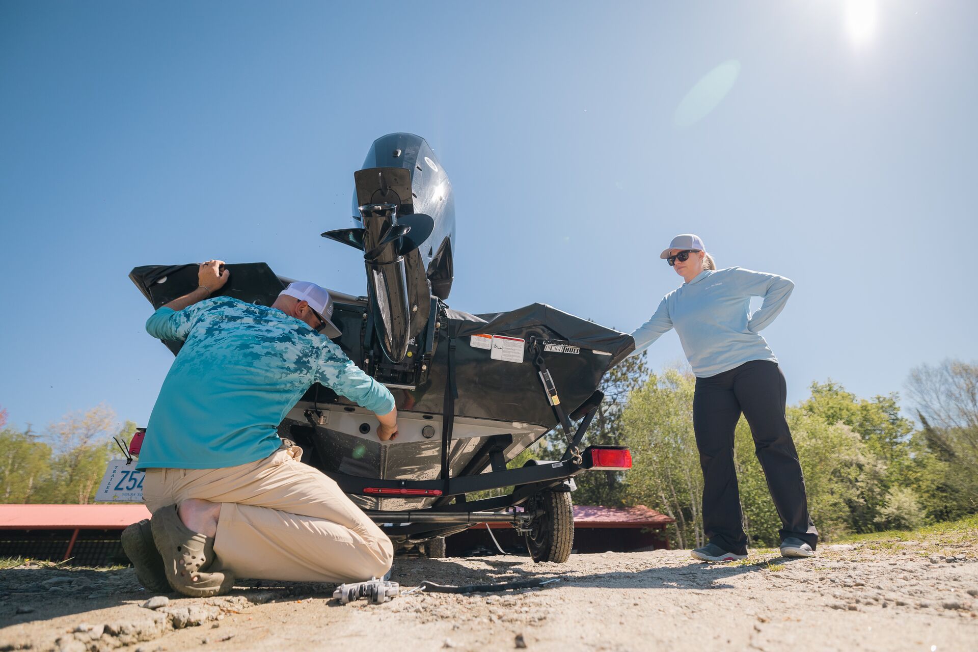 Man and woman get boat ready to launch.