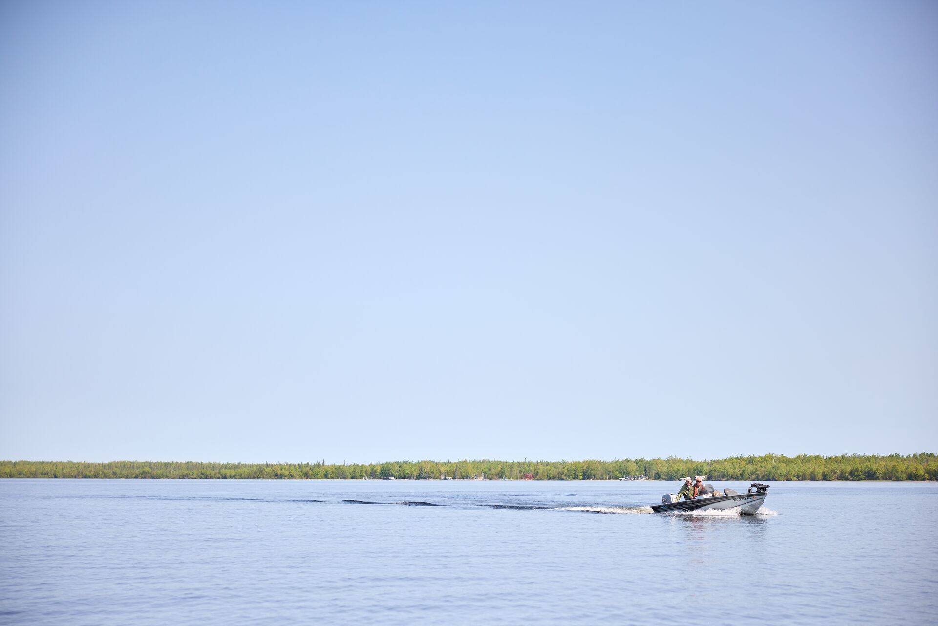 Small boat in the distance on the water, Labor Day boating concept.