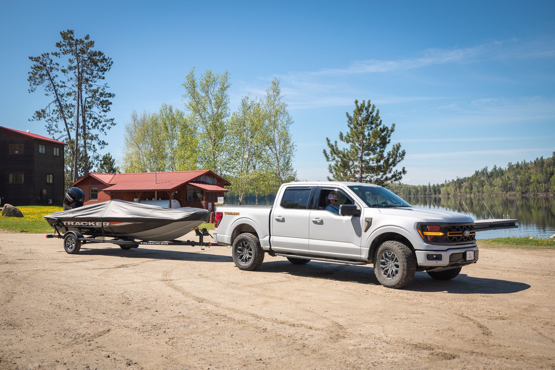 Truck pulling boat on a trailer.