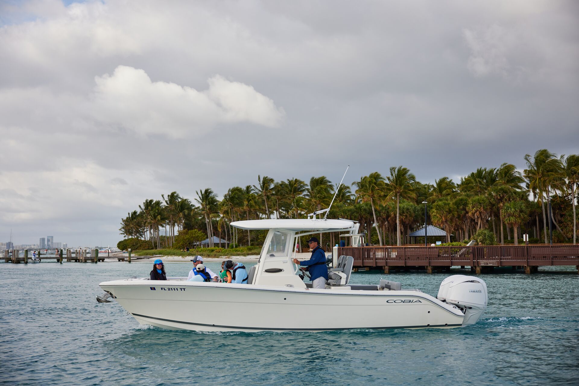 Boat operator drives boat full of people near shore, Captain's License concept. 