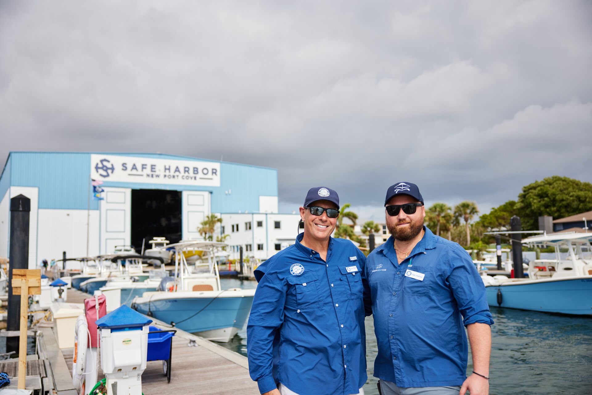Two smiling boat operators on the dock. 