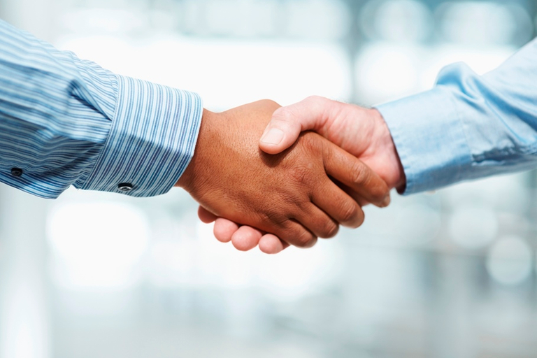 Close-up of a handshake, boat-sharing agreement concept. 