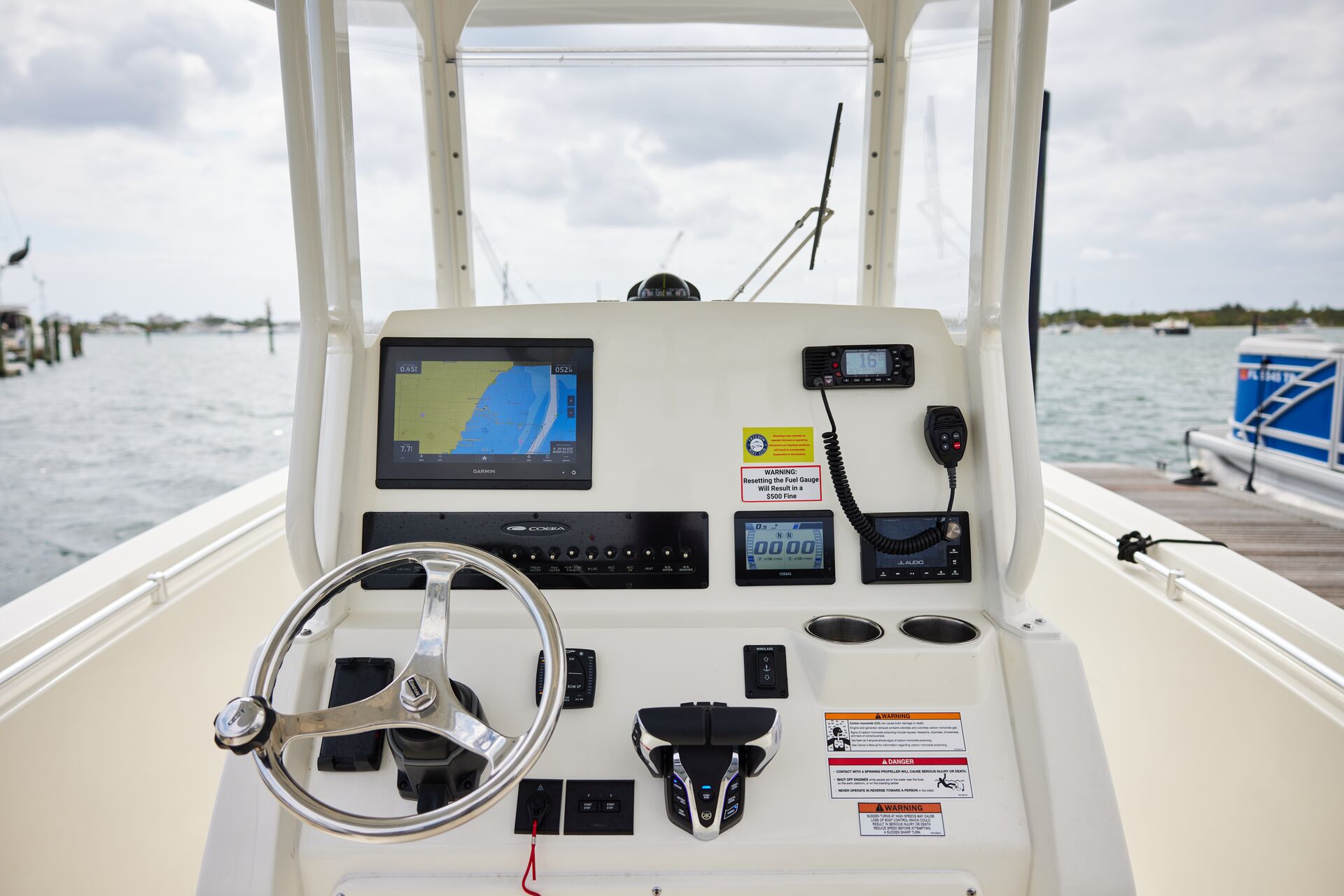 Helm of a boat showing GPS on a screen, learning nautical chart basics concept. 