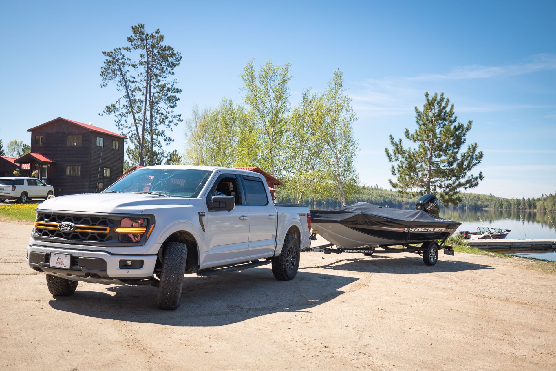 Truck pulls boat on trailer at ramp, how to tow a boat concept. 