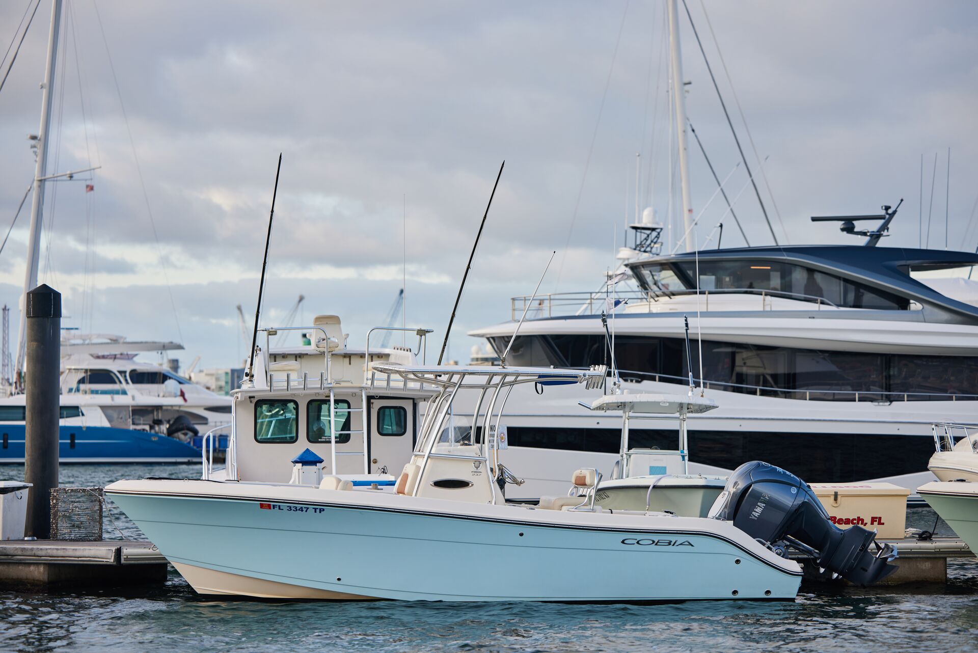 Small and big boats at marina, research boat insurance cost concept. 