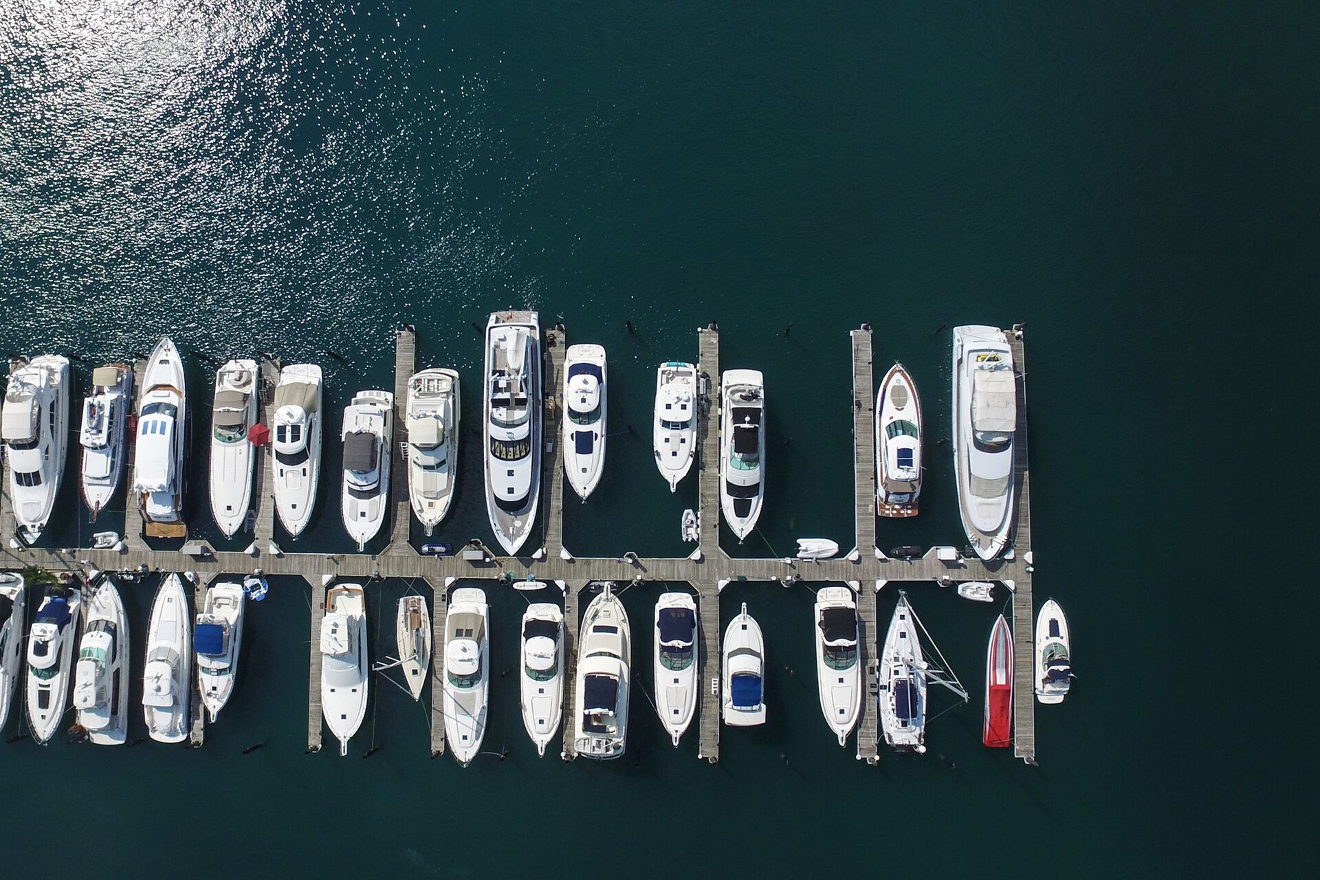 Many boats docked at marina. 