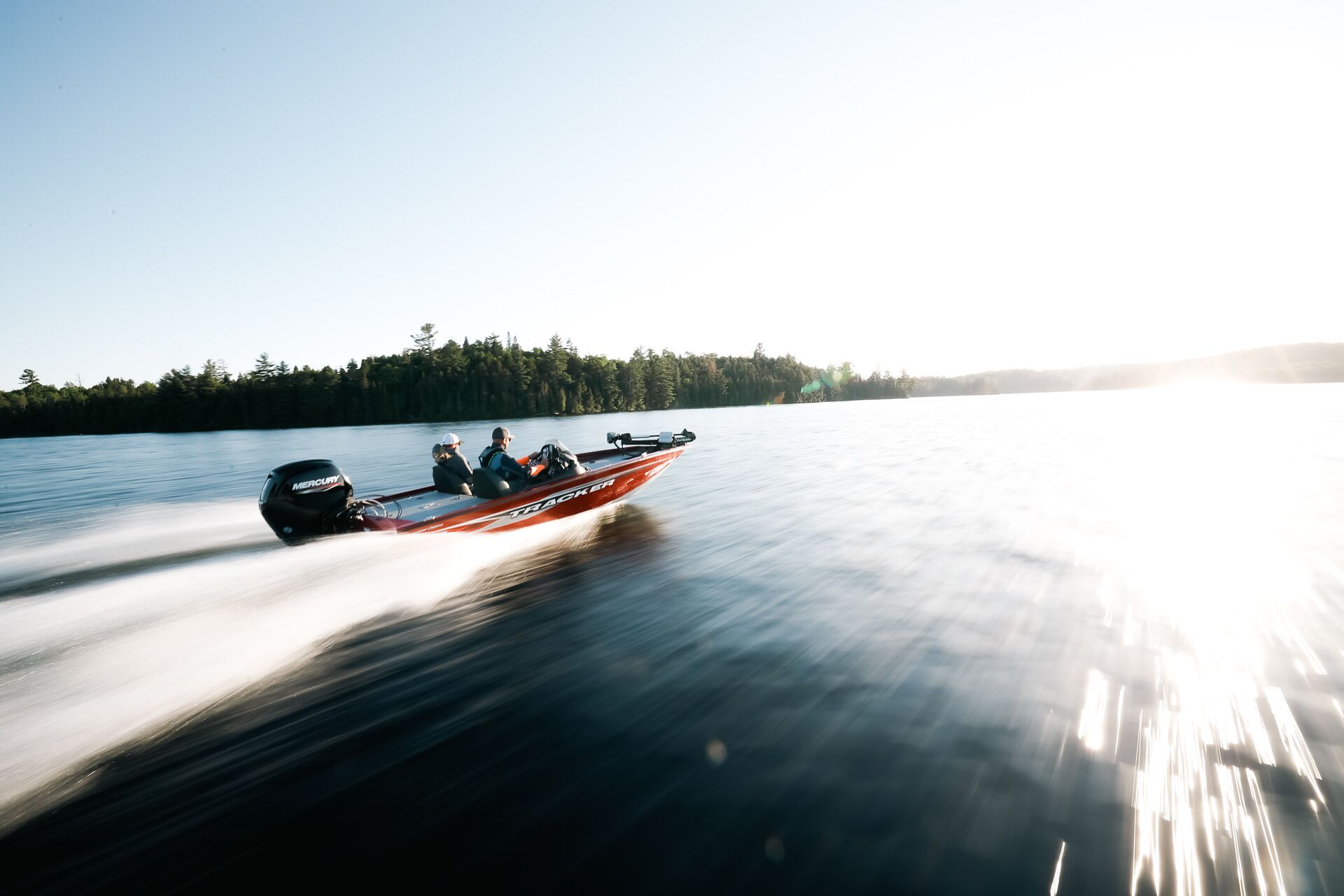 Two people in fast-moving fishing boat on water, US boat license cost concept. 
