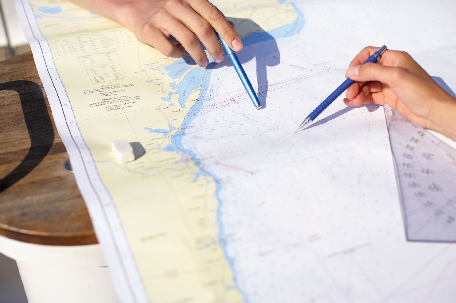 Two hands with navigational chart, intracoastal waterway map concept. 
