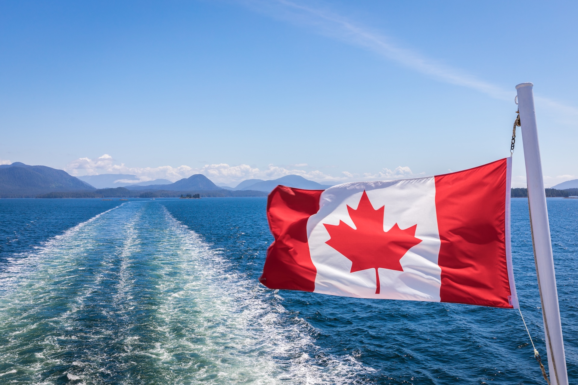 Canadian flag on boat over water, what are Canadian port authorities concept. 