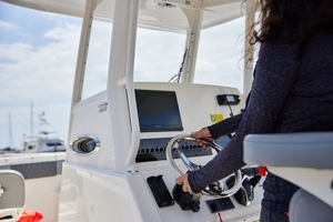 Close-up of woman at boat helm, Oregon boating license requirements concept.