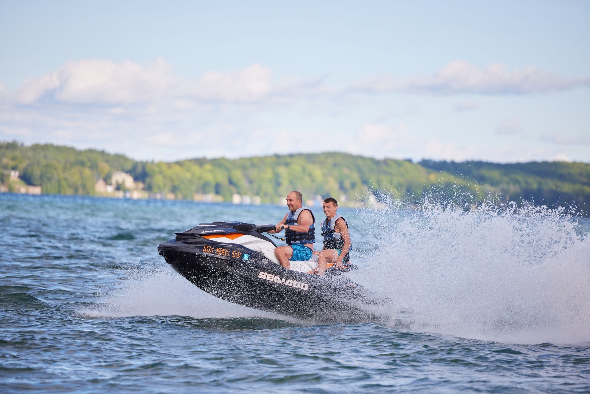 Man and boy enjoy PWC on water, Missouri boating license requirements concept. 