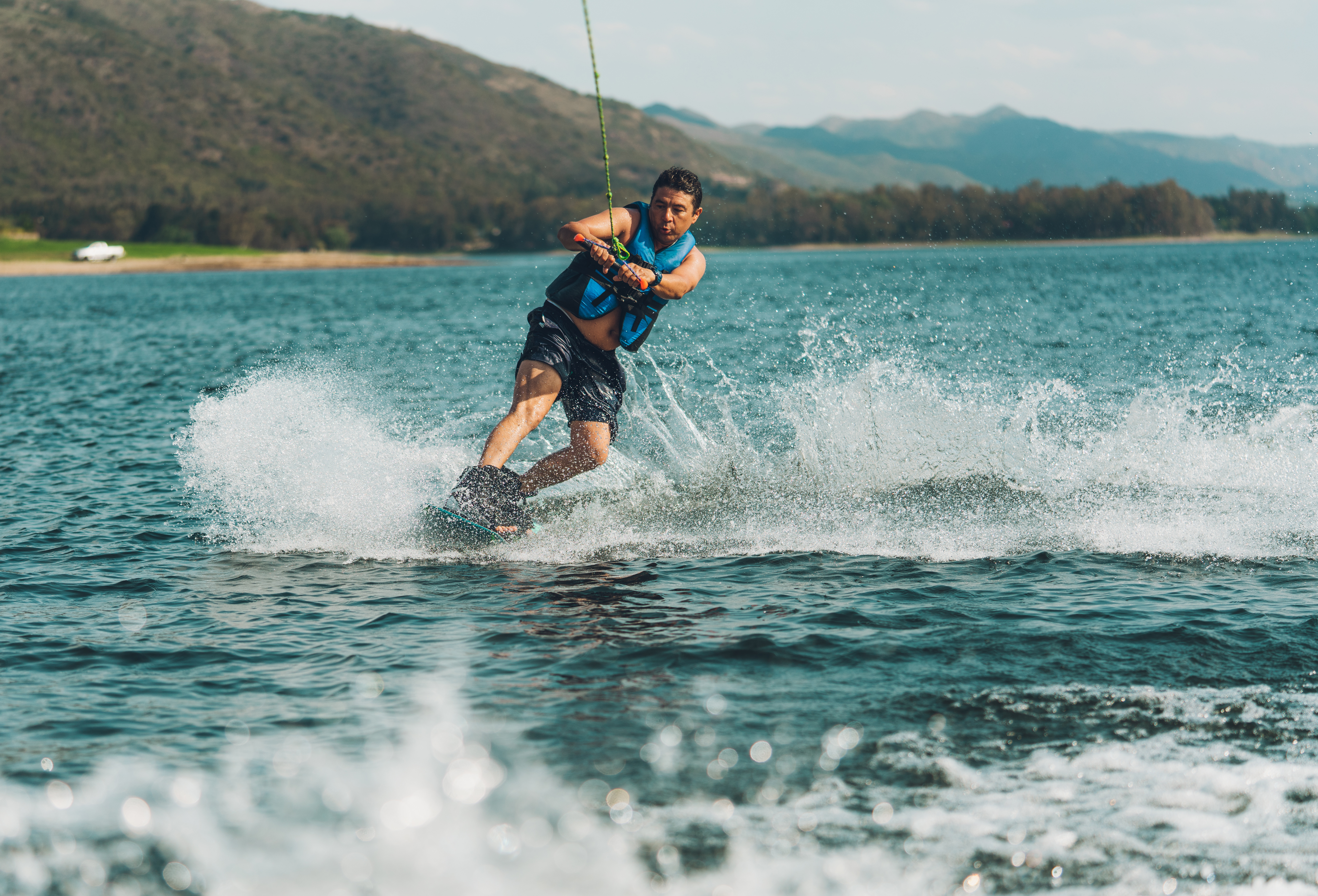 A man waterskis on the water, activities based on boat size concept. 