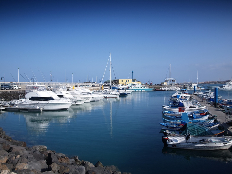 Boats docked at a marina, boat size concept. 