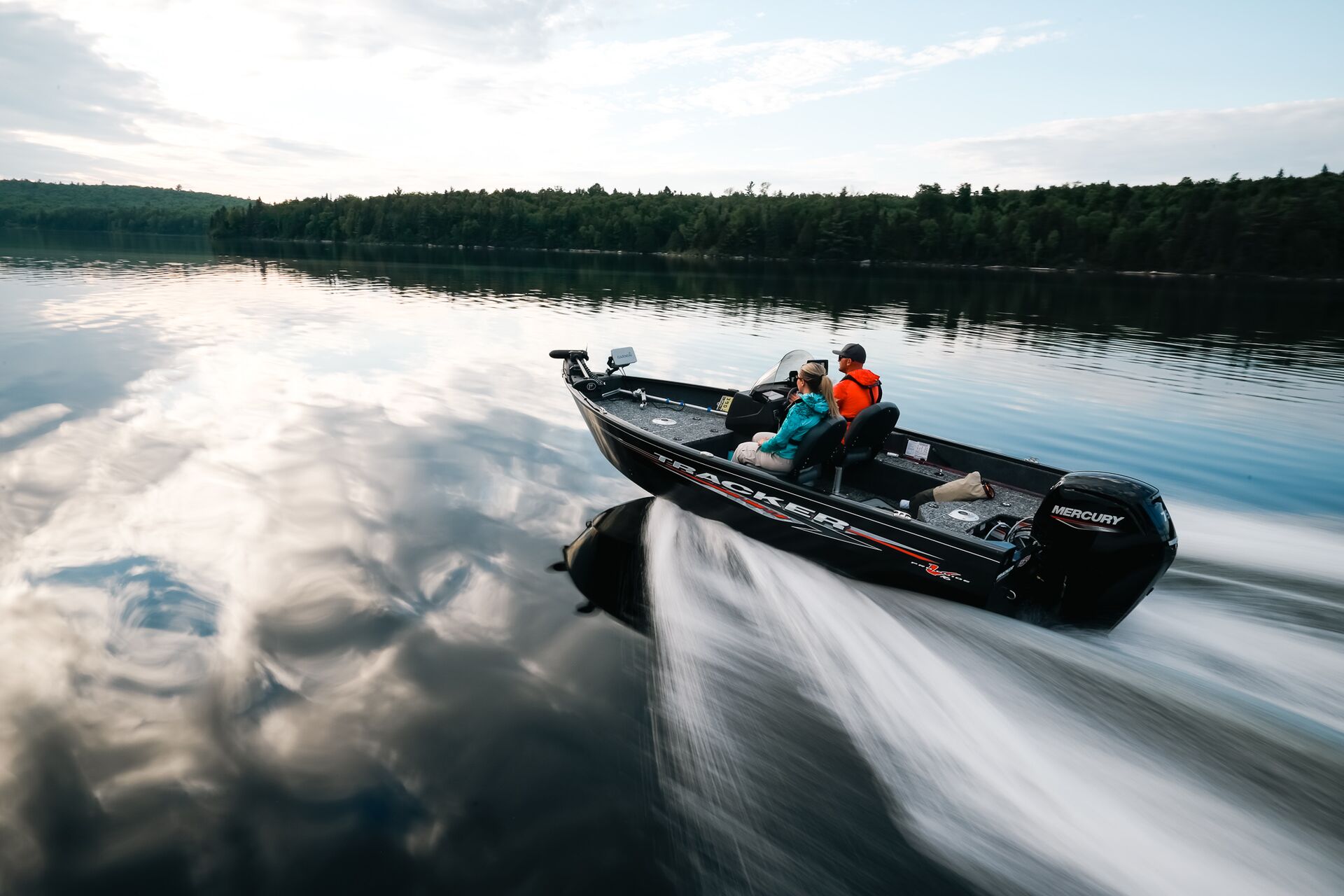 Two people on fast moving bass boat, Texas boater education concept. 