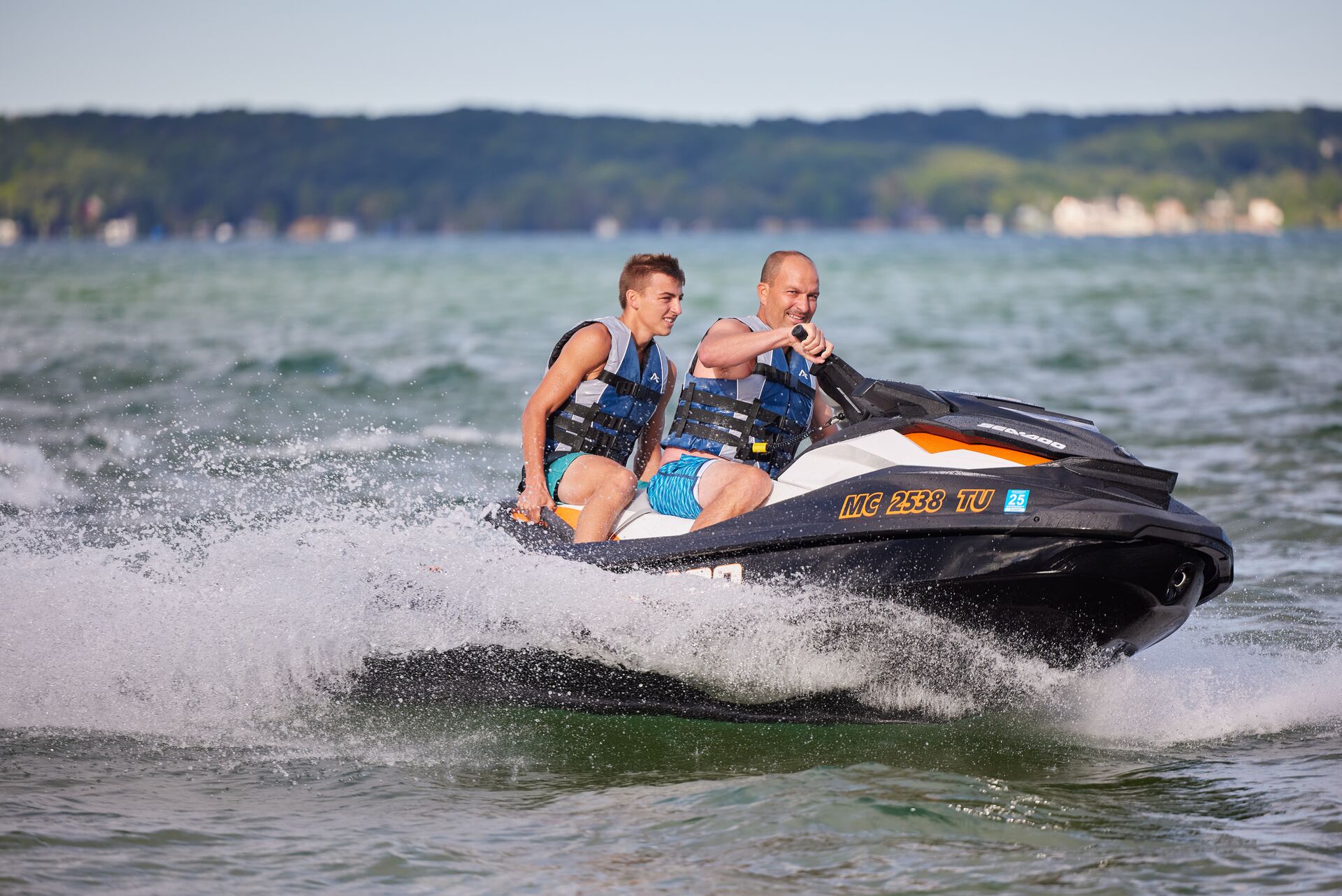 Two guys on a jet ski on a lake, do you need a boating license in Wisconsin concept. 