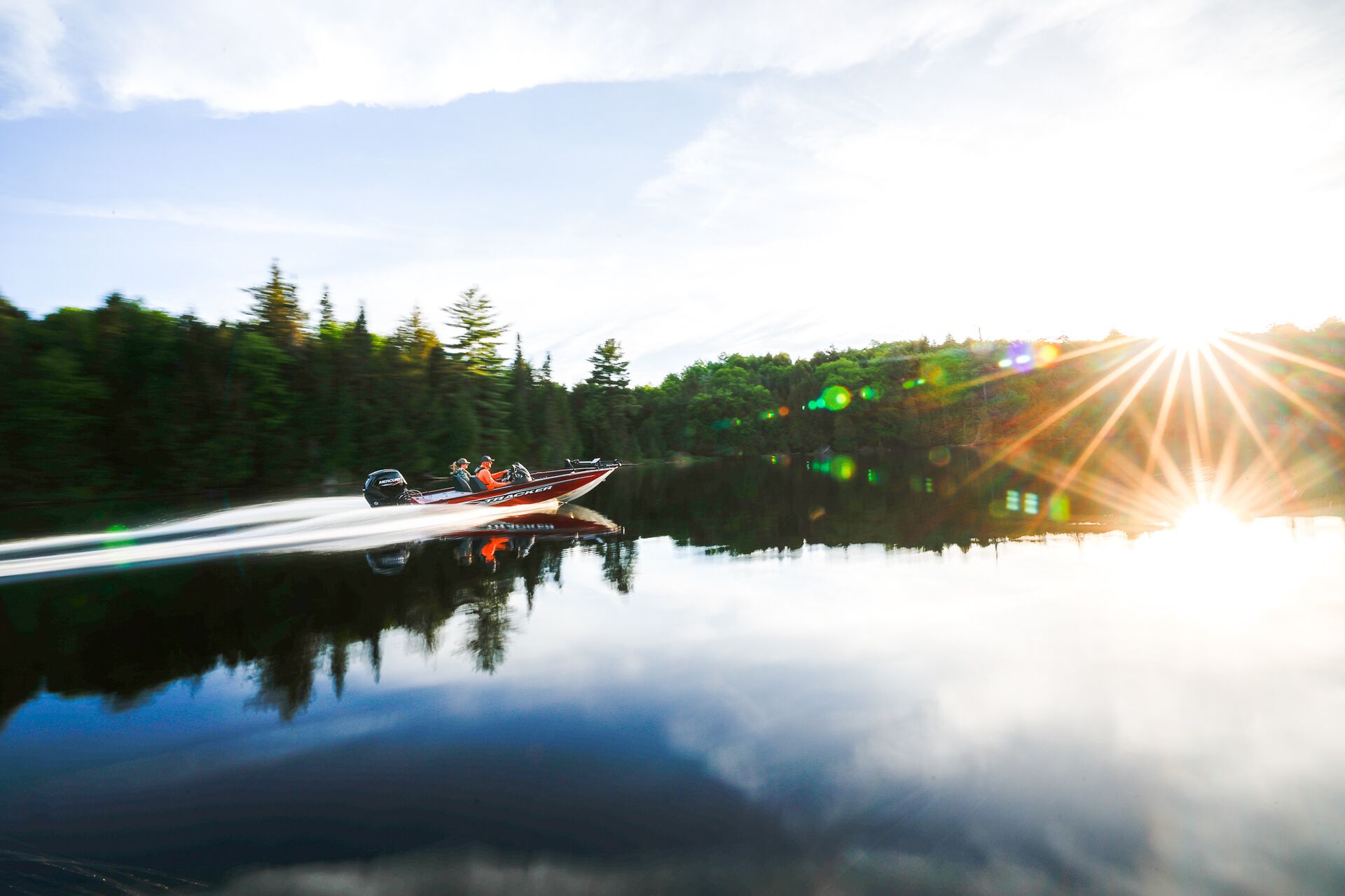 Two people in fast red boat on sunny day, do you need a boating license in Wisconsin concept. 