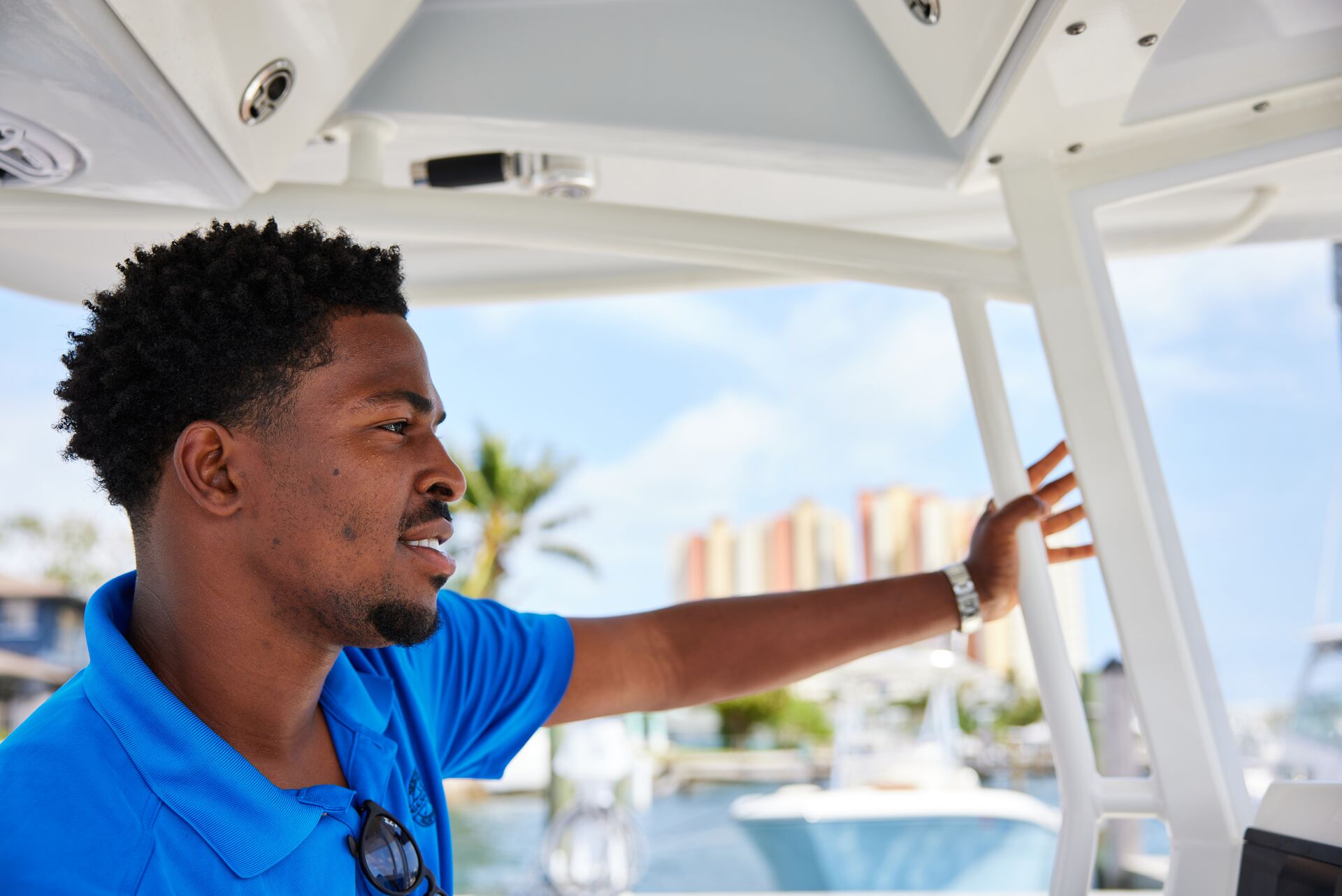 Smiling man drives a boat, do you need a boating license in Michigan concept. 