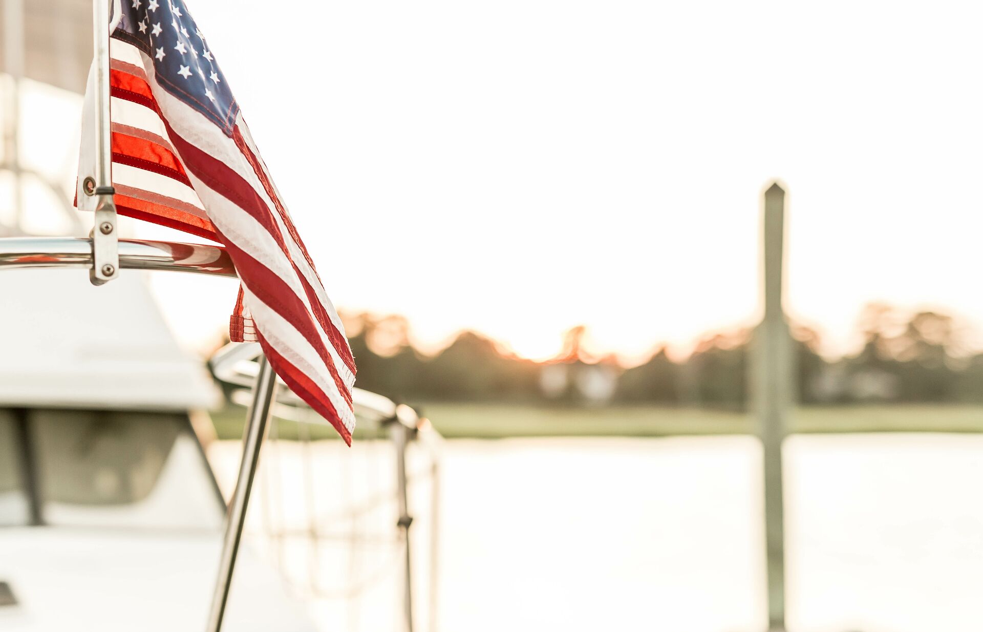 Close-up of US flag flying on boat, Memorial Day boating safety concept.