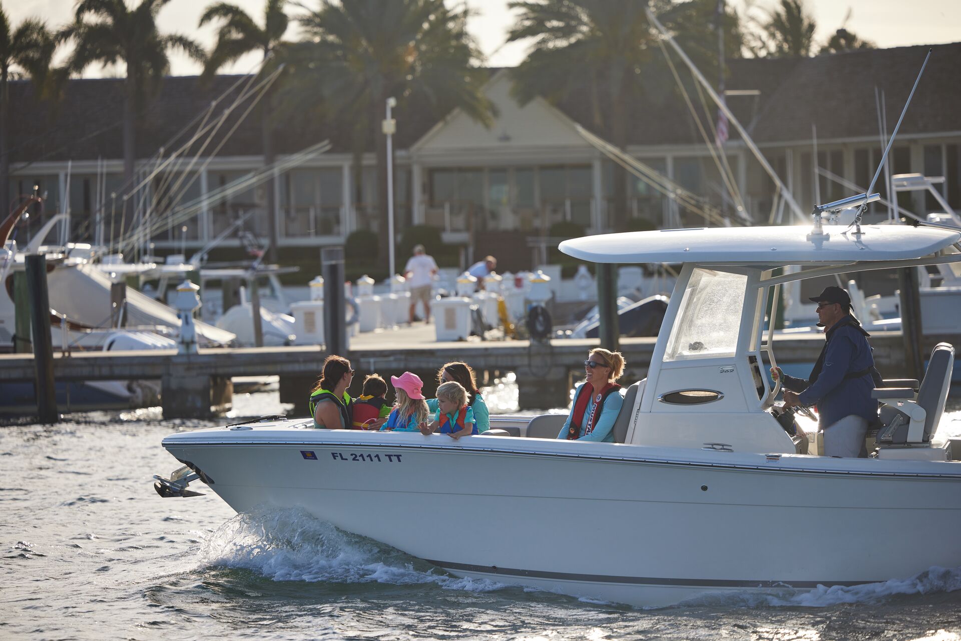 Crowded boat near busy marina, Memorial Day boating safety concept. 