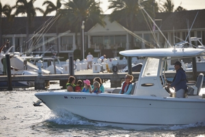 Crowded boat near busy marina, Memorial Day boating safety concept.