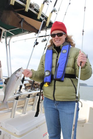 A person displaying a striper fishing catch