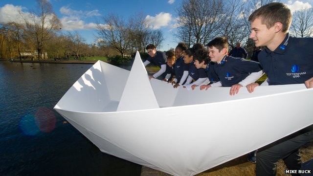 children launching origami boat
