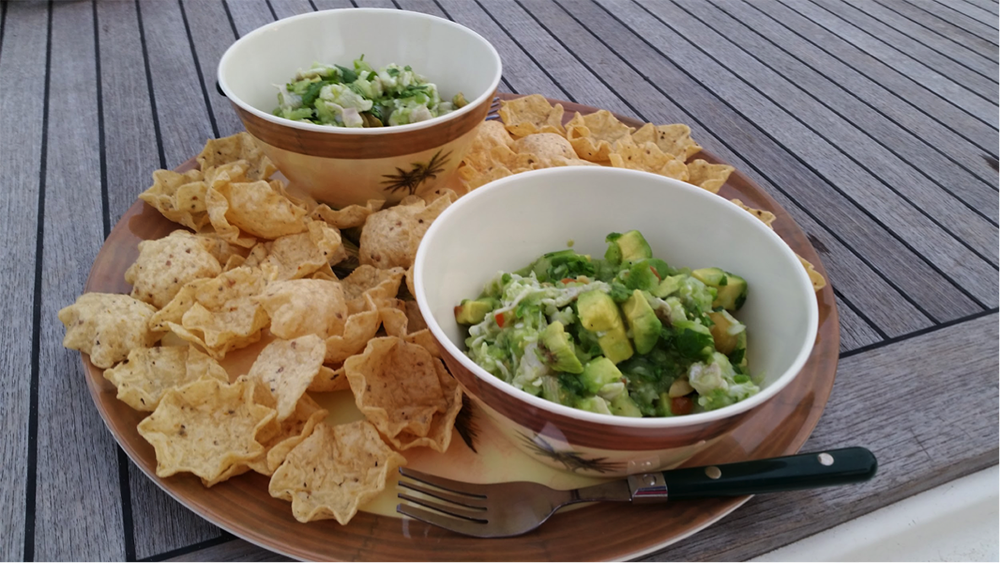 A bowl of ceviche verde with chips. 