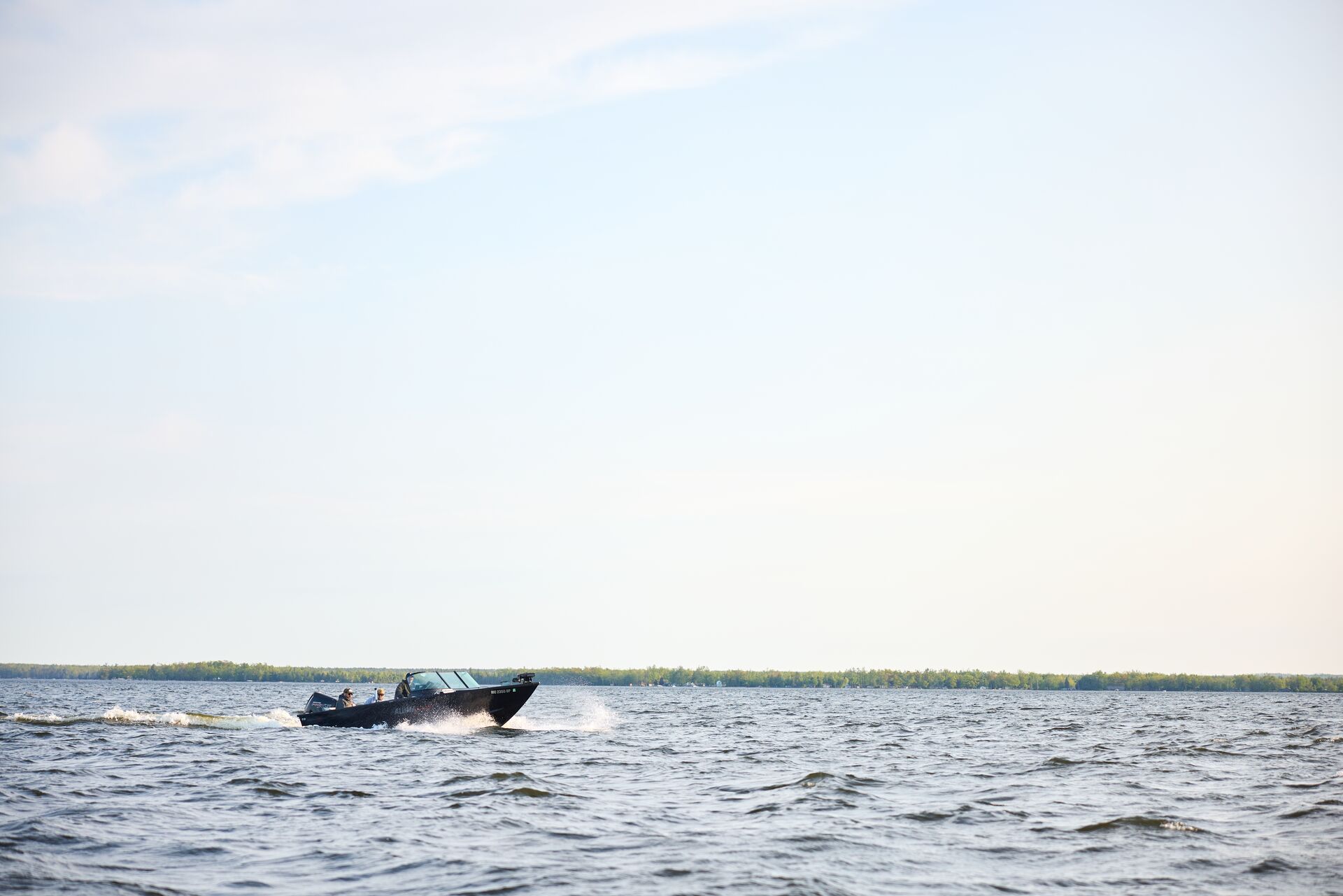 Boat moving on the water in the distance, do I need a boating license  concept. 