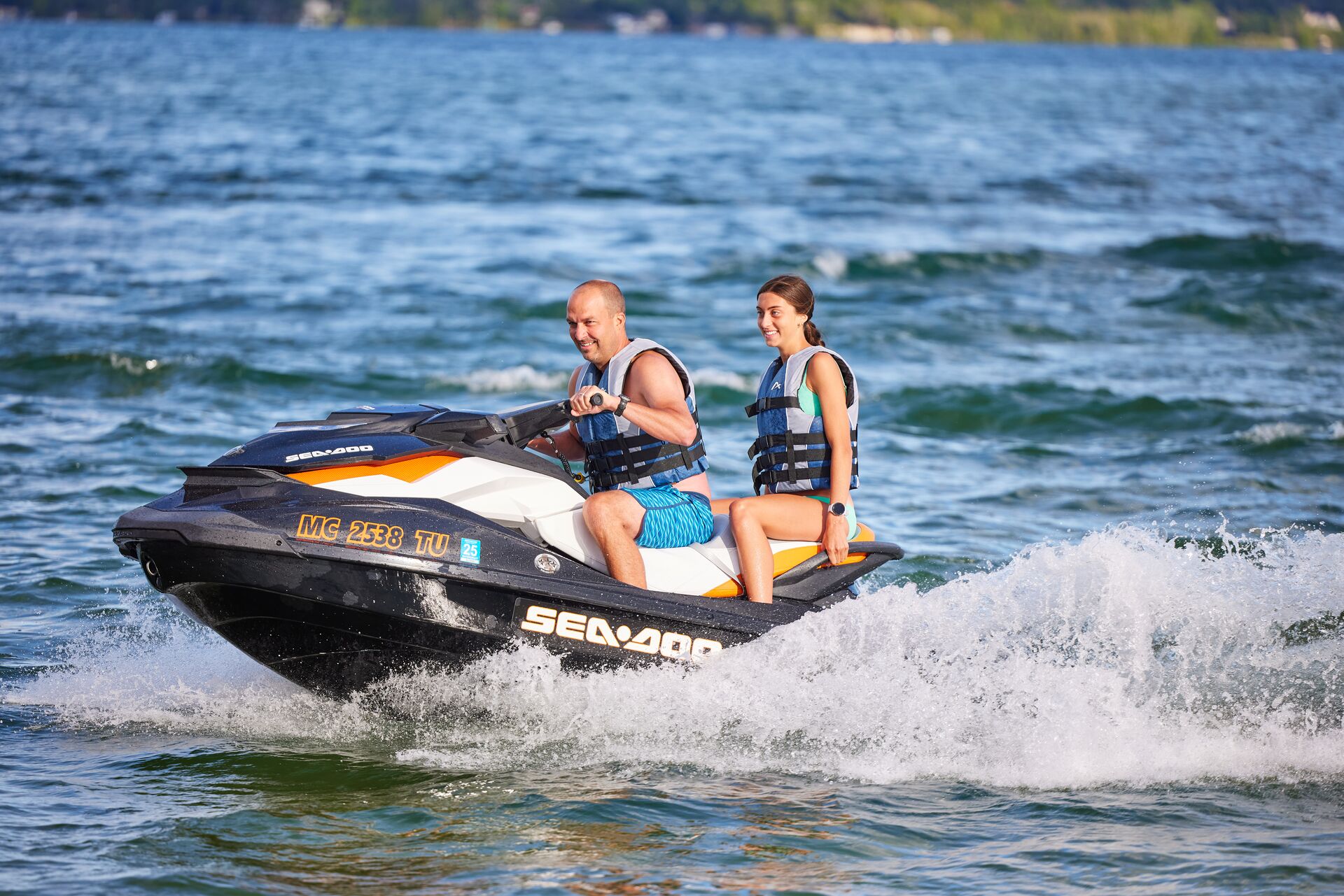 Man and girl wearing lifejackets on jet ski, how many life jackets required on boat concept. 
