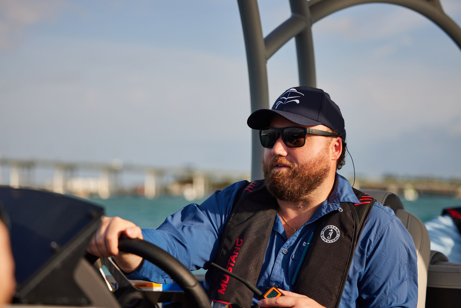 Man in hat and sunglasses drives a boat, get a replacement boater safety card concept. 