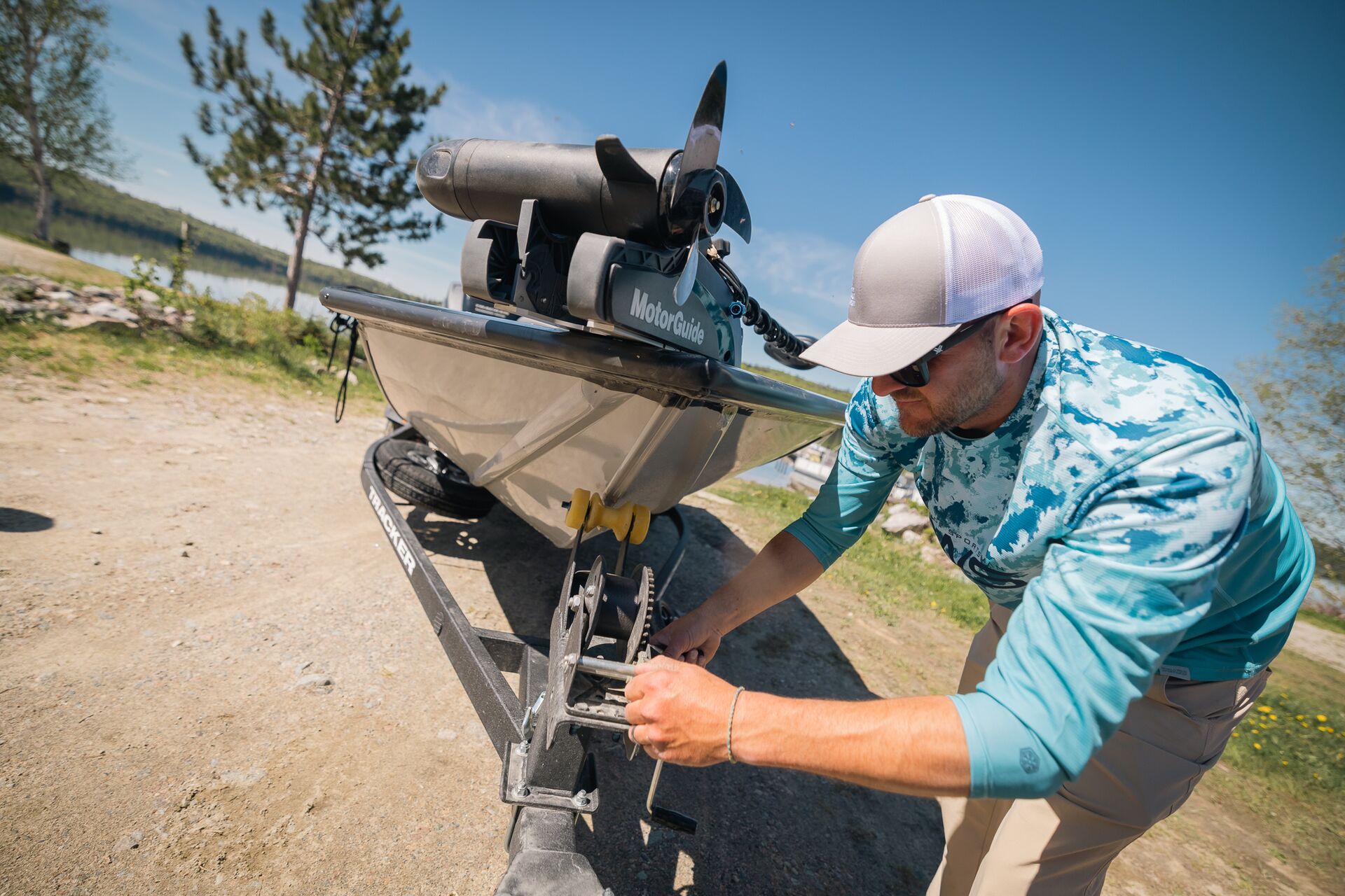 Man adjusts trailer with boat on it, do you need a license to rent a boat in New York concept.