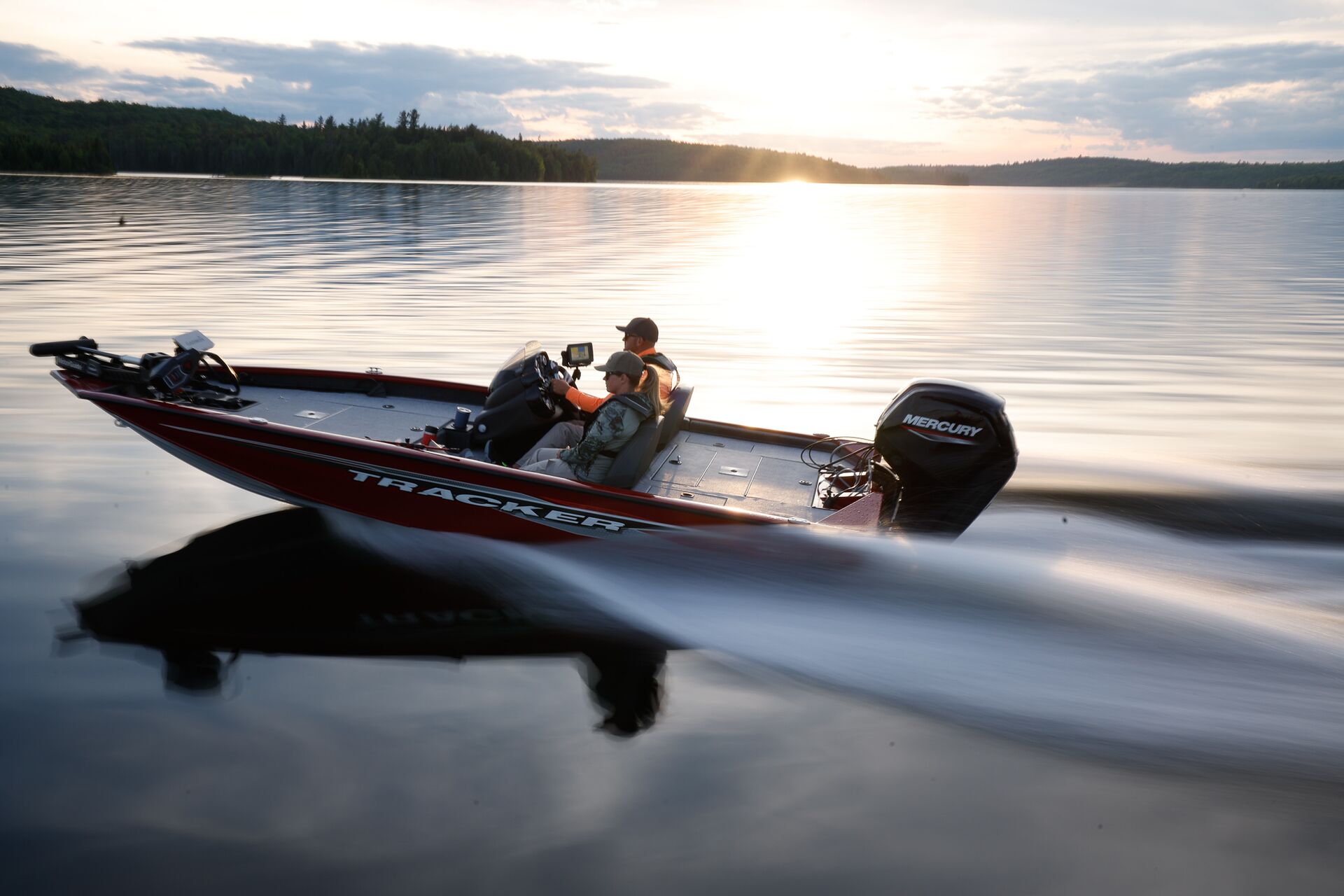 Two people in red bass boat, California boat rental license concept. 