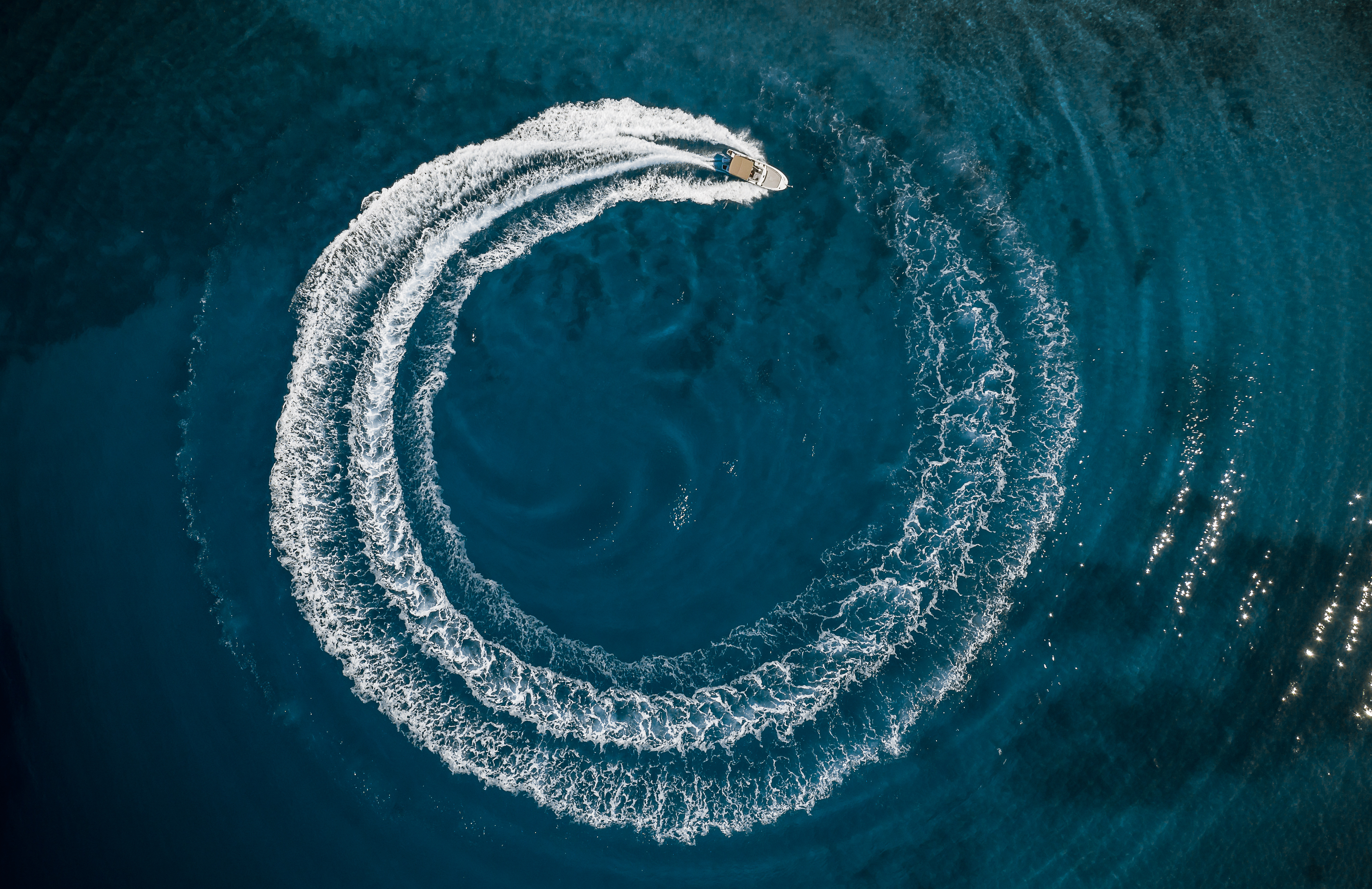 A boat driving in a circle to create a wake, bananas are bad luck on a boat concept. 