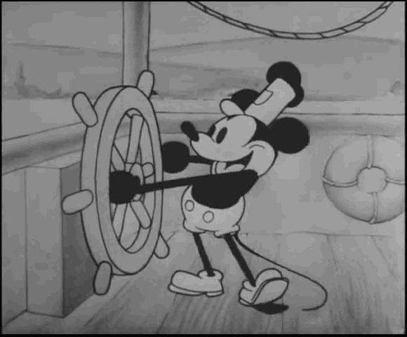 Screenshot of Mickey Mouse at the helm of the boat in Steamboat Willie, boating movies concept. 