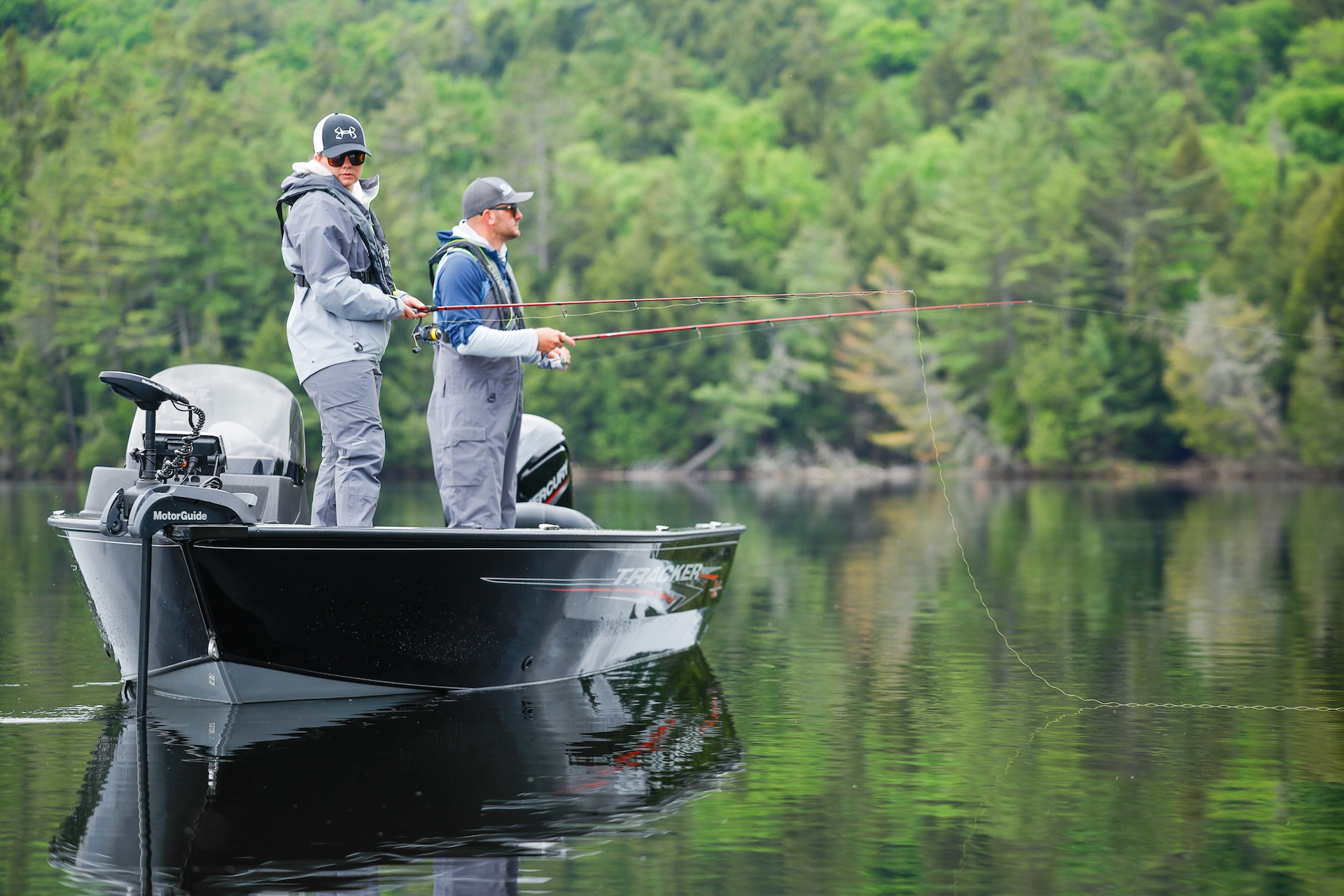 Two anglers on a boat with fishing lines in the water, Texas fishing concept. 