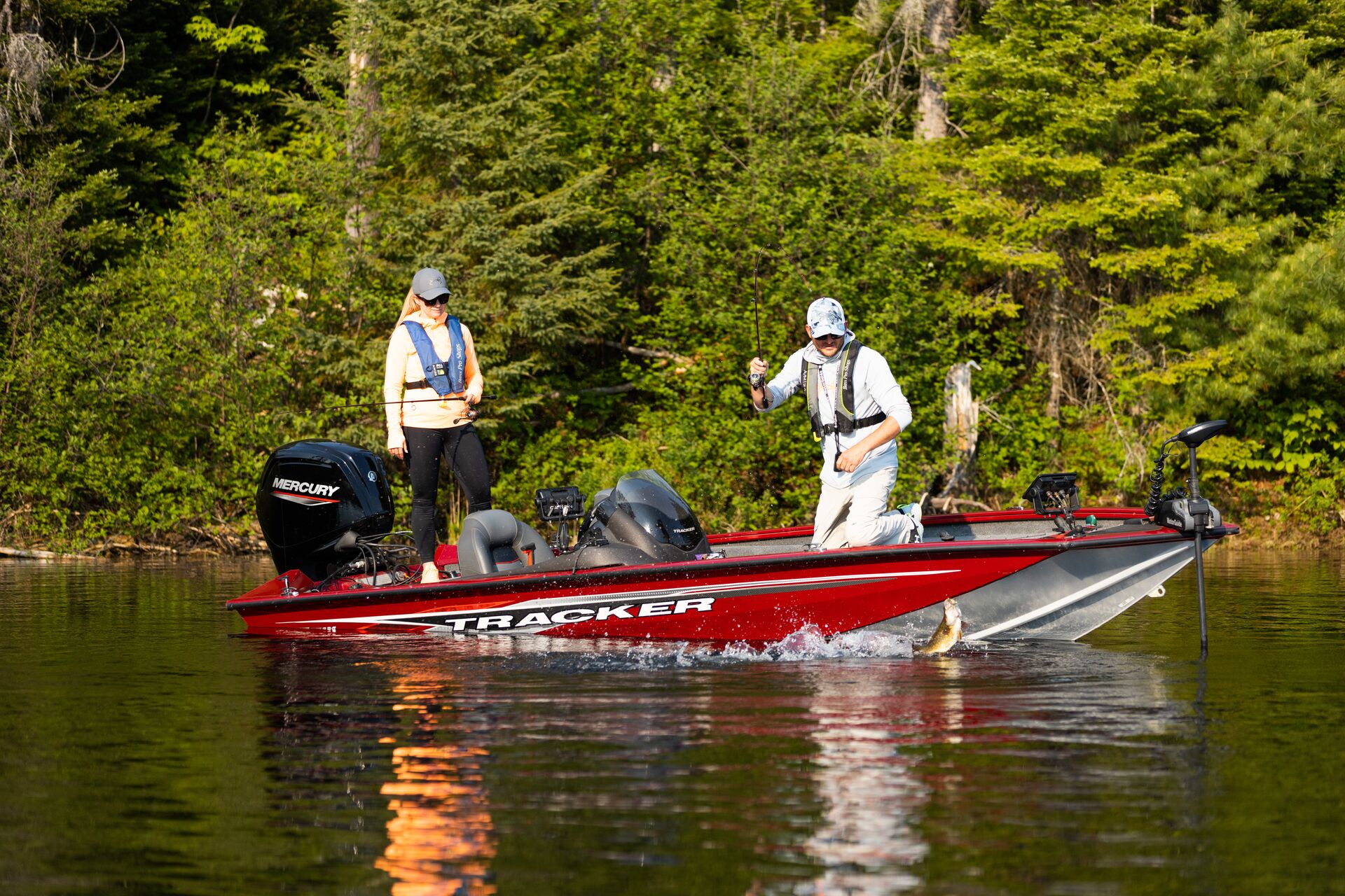 A man and woman fishing from a boat. 