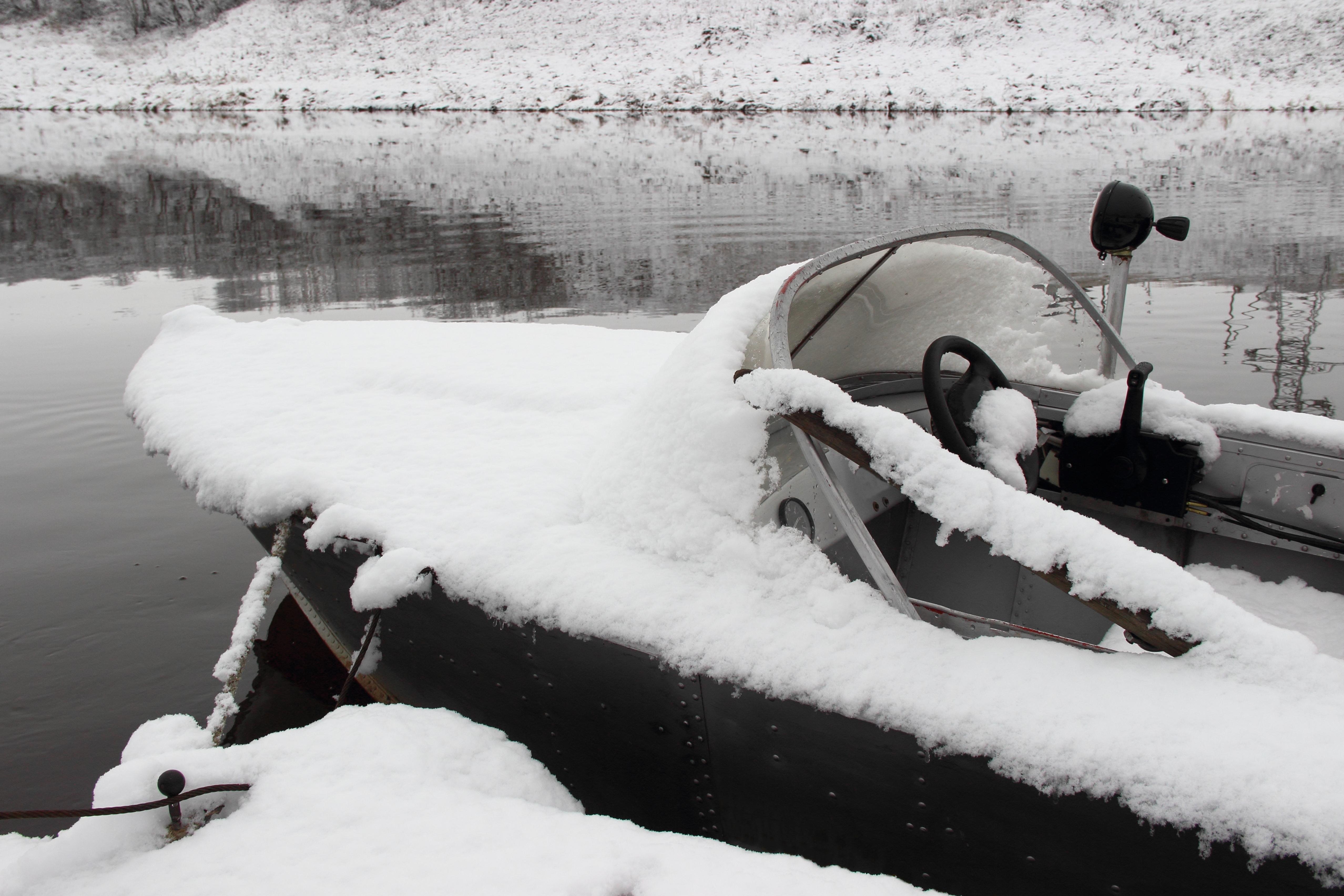 A boat covered in snow, no boat winterization concept. 