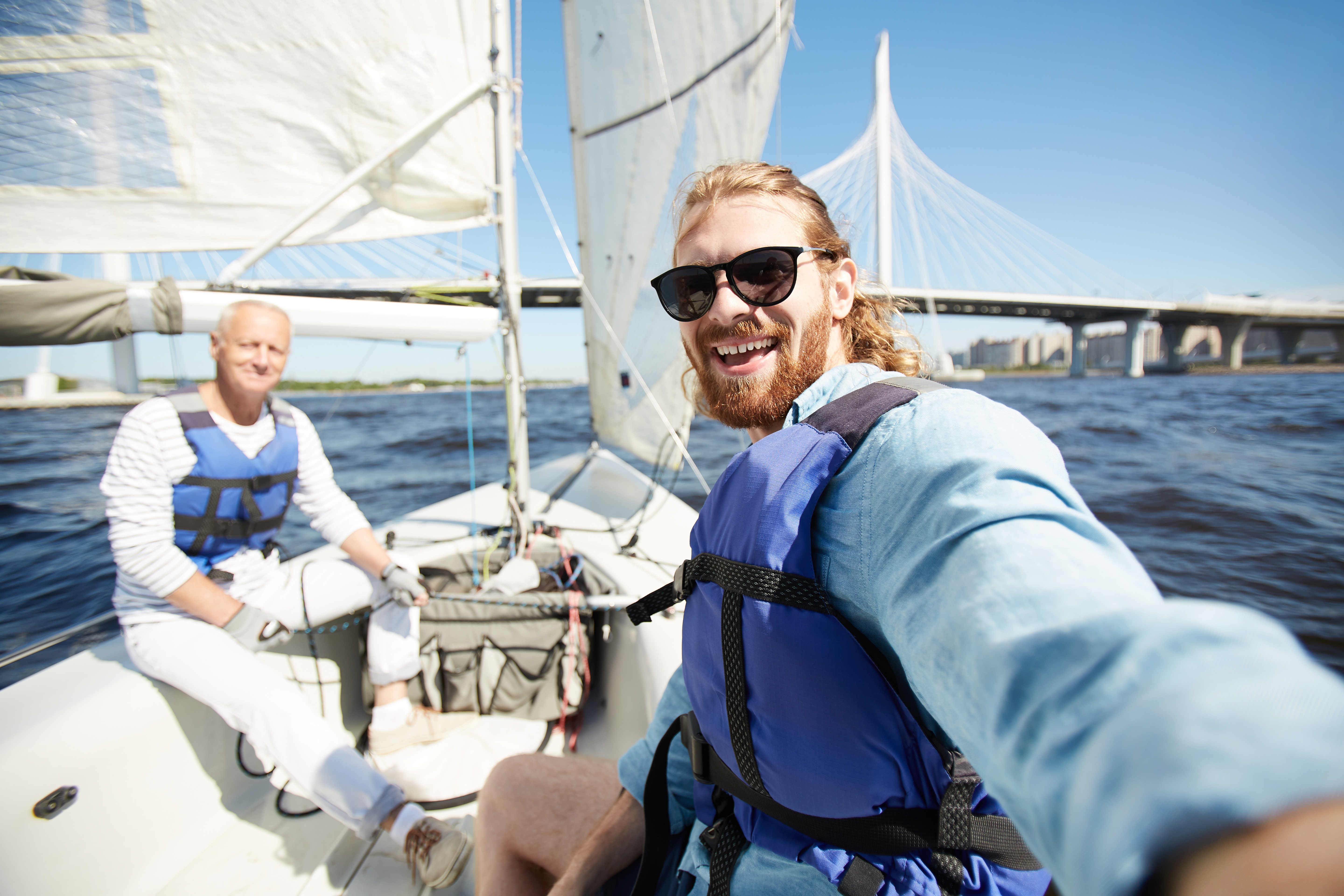 Men on a sailboat, do you need a license for sailboats concept. 