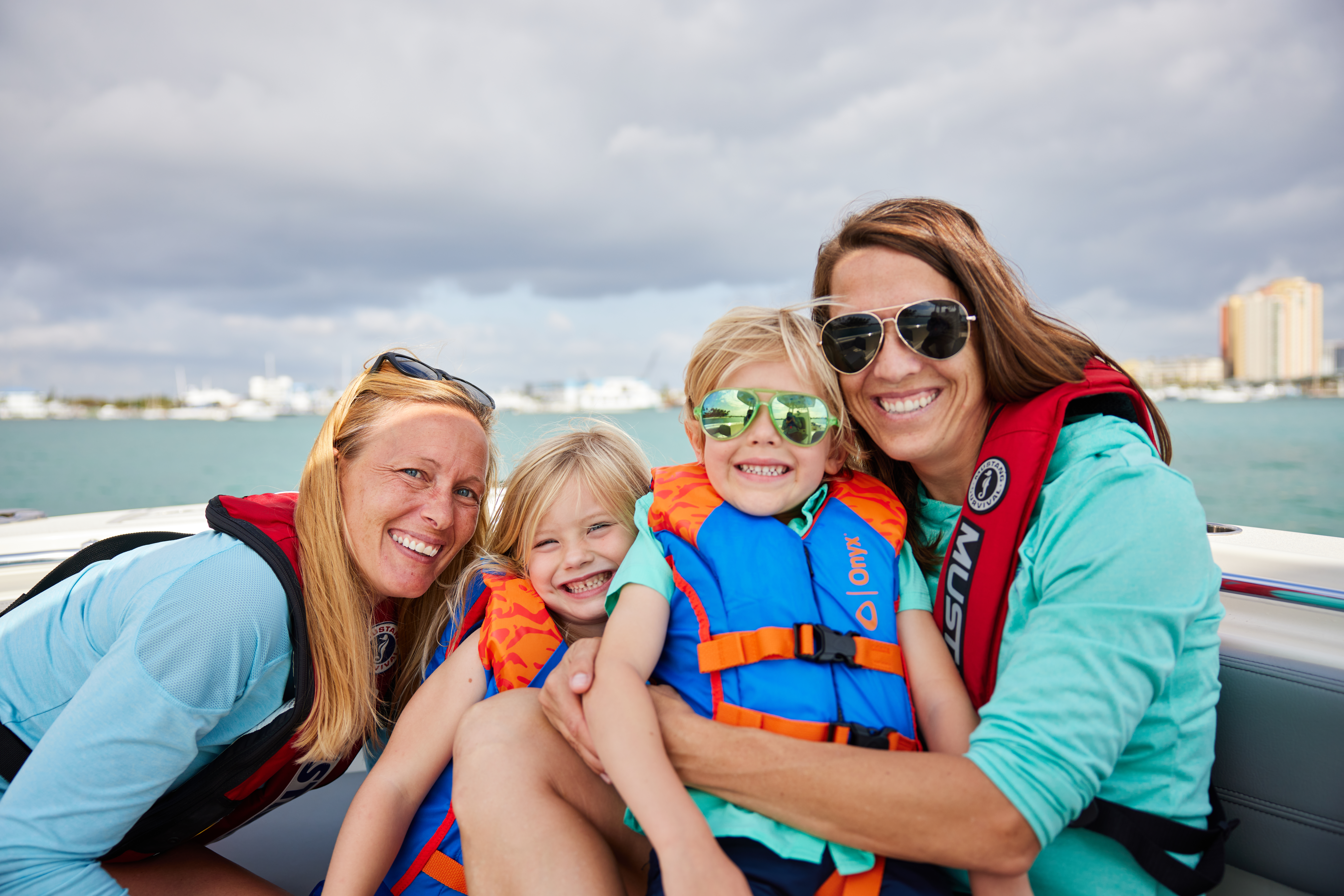 Children and women wearing PFD life jackets. 