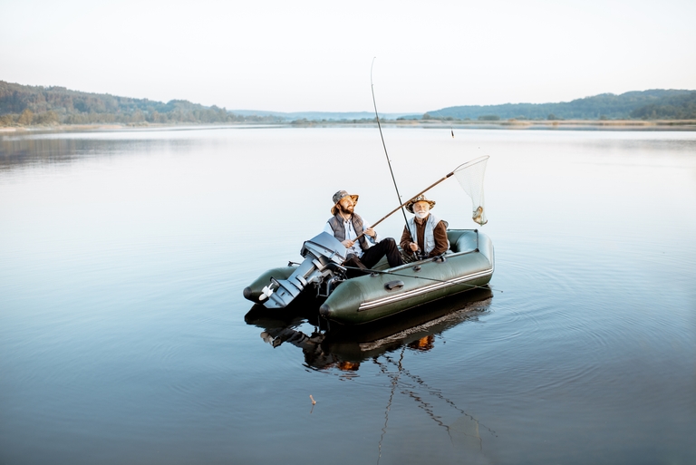 Two men fishing for bass from a boat. 