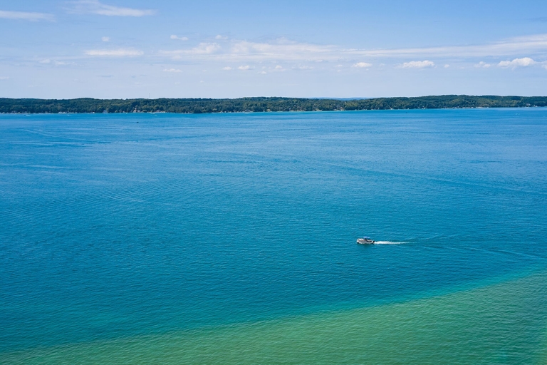 A boat in the distance on a lake, Wisconsin boat rentals concept.