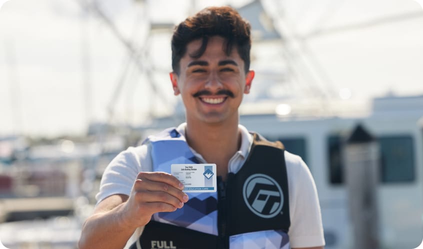 a-smiling-man-in-a-lifejacket-holding-a-boater-safety-card-boating-on-lake-tahoe-safely-concept. 